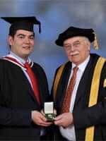 Michael Randall being presented with the medal by the Chancellor, Lord Tanlaw