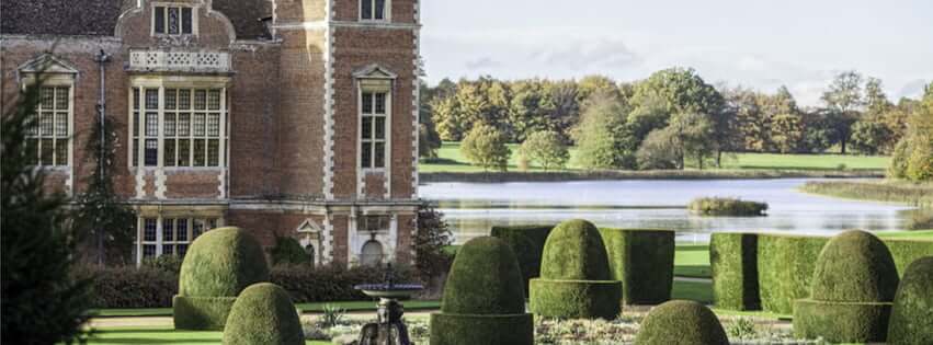 Large country house looking over landscaped gardens