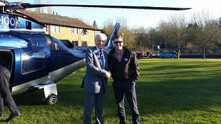 Nigel Adams greets Adam McGill who arrived at Buckingham by helicopter