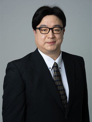 Professional studio photograph of Dr Kazuhiro