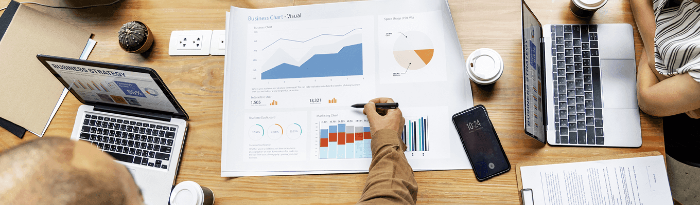 Graphs and laptops in business meeting