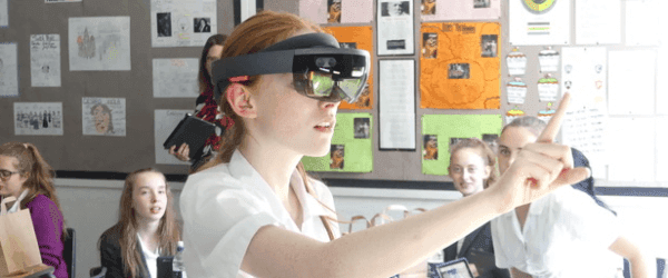 A school age girl wearing an augmented reality headset