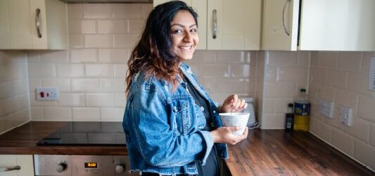 student making a drink in student accommodation