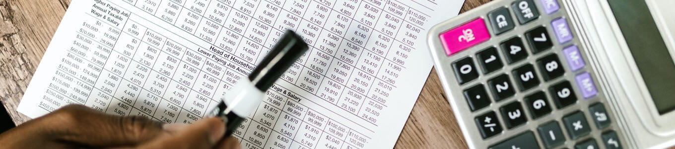 Financial paperwork and calculator on desk