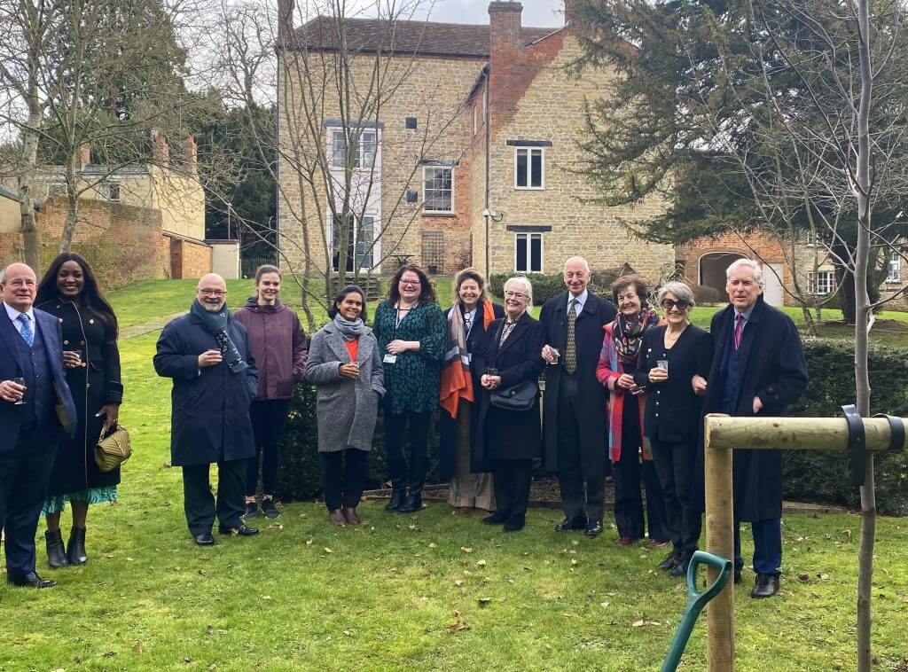 James Tooley, university staff and guests gather to plant tree on university grounds
