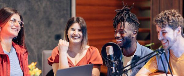 Group of young students in podcast/audio studio