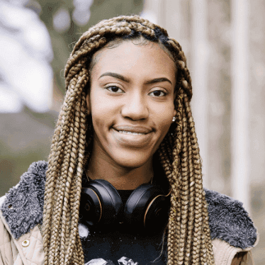Reni, female undergraduate student, smiling to camera.