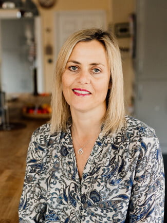 Portrait photograph of Katie Nyanken, smiling to camera