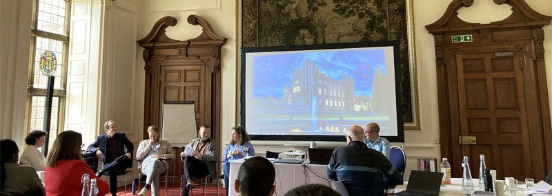 Group of people gathered in stately room of Madingley Hall