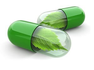 Two green pills. Both have one half green, the other half transparent with green leaf within the capsule