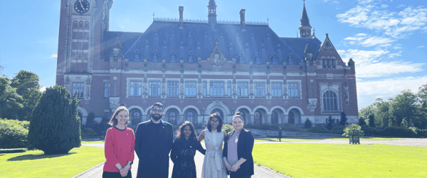 Coach Dr Jessica Walsh, Wajahat Mahmood, Maneeka Bjuhun, Sonali Bhujun, and Megan Priestman in front of the Peace Palace in the Hague