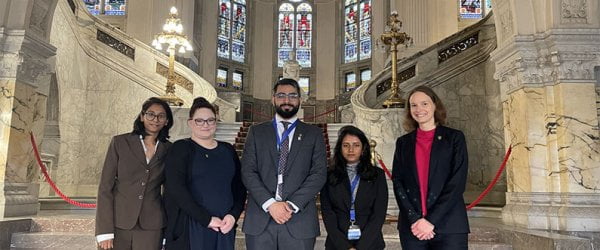 Law students smiling to camera at Law competition