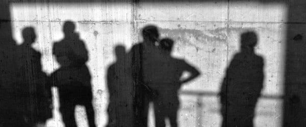 Group of people's shadows against outdoors wall