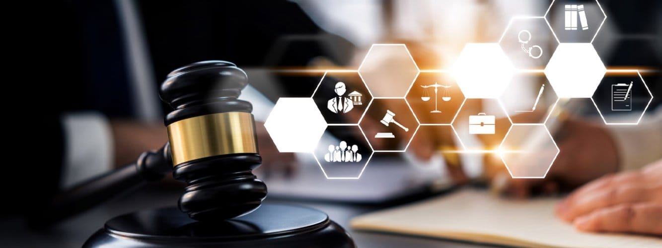 Gavel in forefront of image, with person using laptop. Modern tiles with legal icons overlay the image.