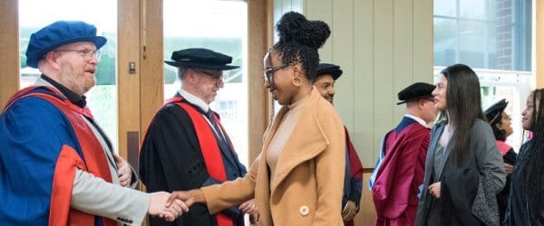 New students shaking hands with University Deans at matriculation