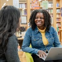 Students smiling, talking to each other in Vinson Building