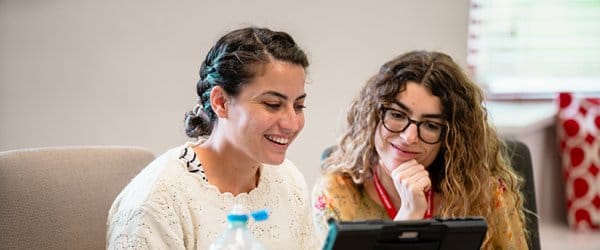 Two women looking at a computer