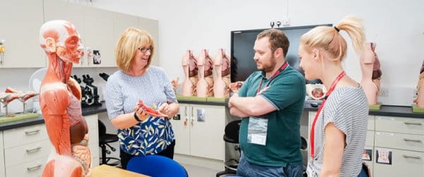 Staff and students working in the Medical school with model of human body