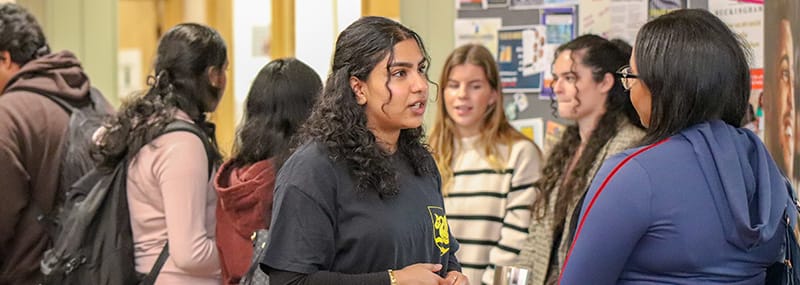Student ambassador speaking to guest at LawFest