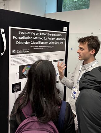 Ethan talking about his work to attendee of the conference