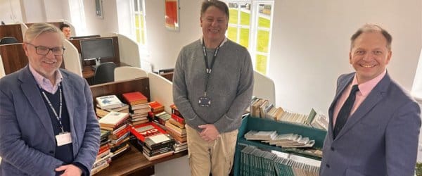 Professor Julian Richards, Malcom Meadon-Pratt and Sergei Cristo at the library with the collection