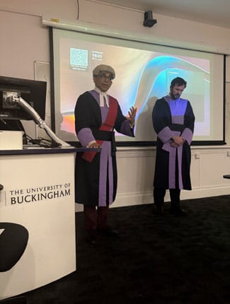 Judges speaking at front of lecture theatre 