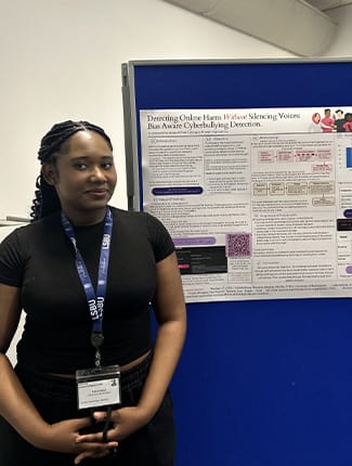 Dianah standing next to her poster